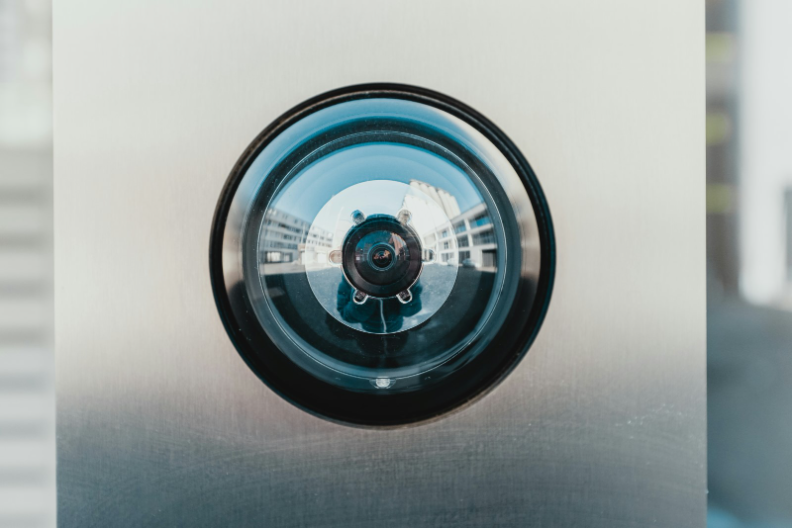 The Dark Side of Personalization article cover: security camera lens in metal