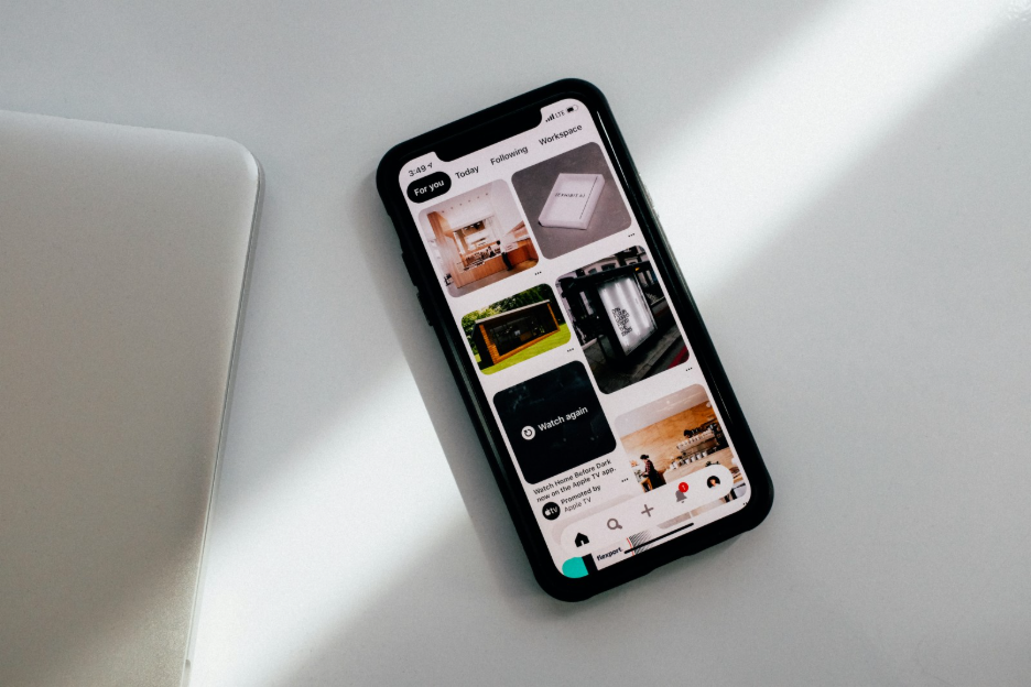 Smartphone and laptop on a desk — context-first design beyond mobile-first breakpoints