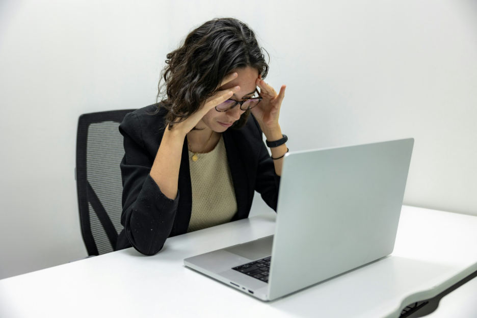 Stressed digital team member at a laptop after a website redesign that failed to deliver results